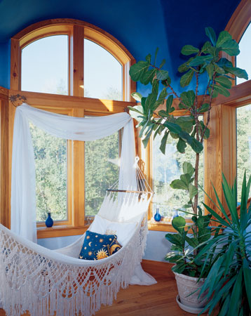 Originally created as a place to watch lightning storms, this lofty space atop the house became known as the sky room. With walls painted in graduated shades of blue Bioshield pigment, it now provides family members with a retreat and is a particular favorite of children.